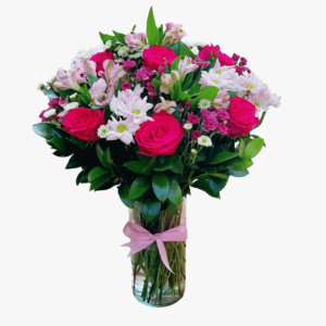 A flower arrangement of Roses, Alstroemerias, and Chrysanthemums with greenery in a glass vase.