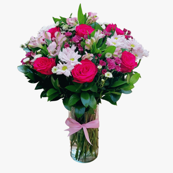 A flower arrangement of Roses, Alstroemerias, and Chrysanthemums with greenery in a glass vase.