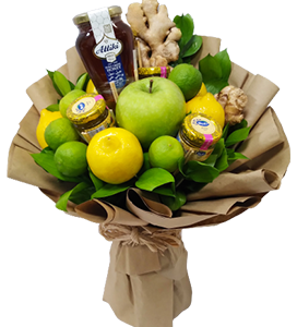 A bouquet of healthy fruits and vegetables with honey and greenery