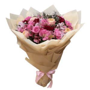 A bouquet of pink and red flowers in elegant wrapping